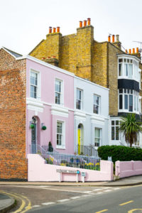 Colourful terrace buildings on a road.