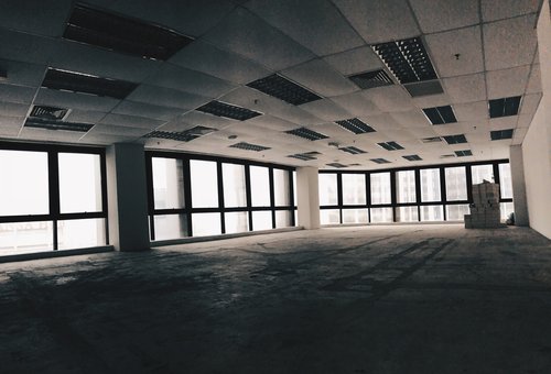 Inside an empty, tall office block in need of a commercial building survey